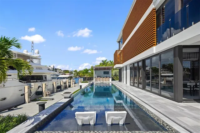 a view of a patio with couches table and chairs with potted plants