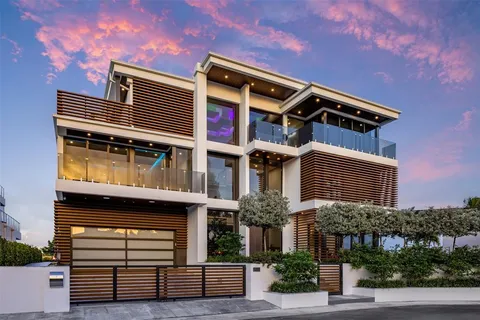 a view of a house with swimming pool and sitting area