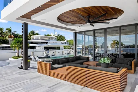 a living room with furniture a ceiling fan and a large window