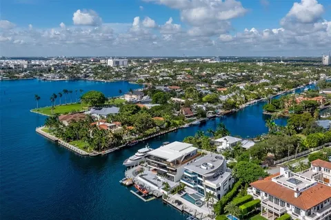 an aerial view of a house with outdoor space swimming pool and lake view in back