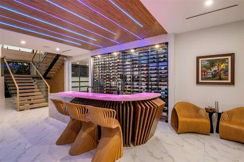 a dining room with furniture and a potted plant