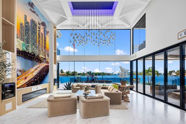 a living room with furniture and a floor to ceiling window