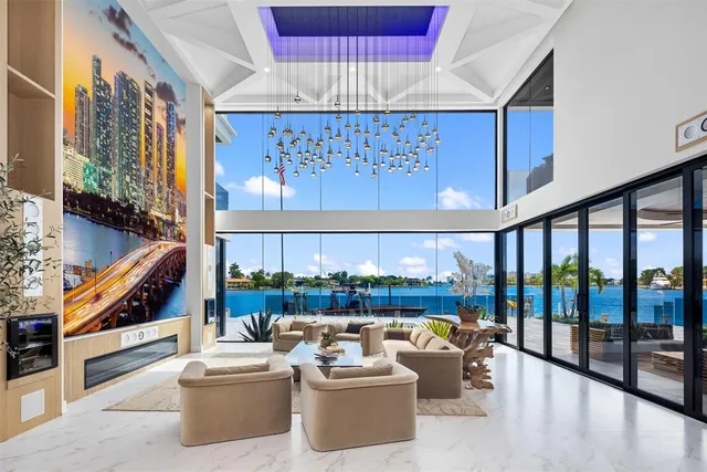 a living room with furniture and a floor to ceiling window