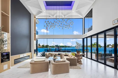 a dining area with furniture a chandelier and a rug