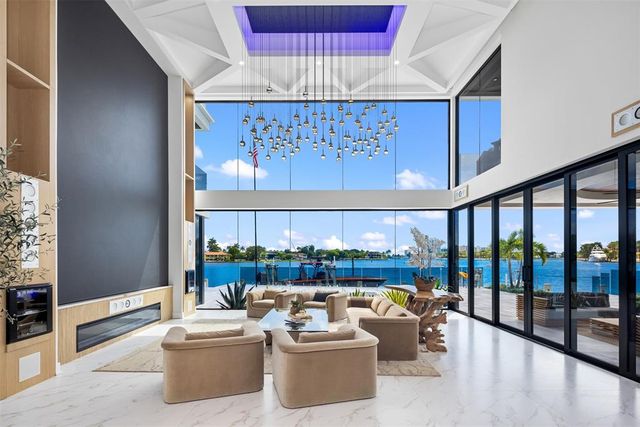 a dining area with furniture a chandelier and a rug
