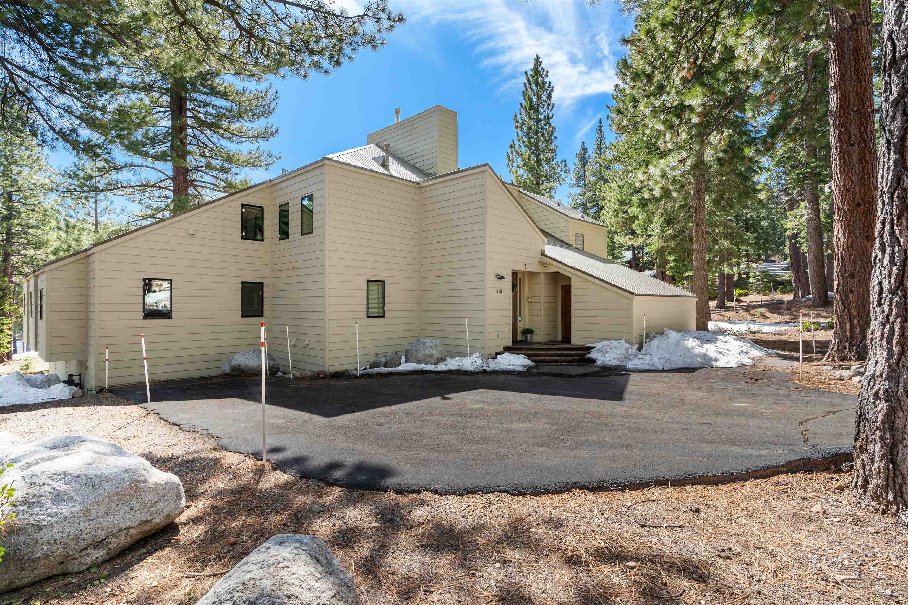 519 Wolf Tree Truckee, CA 96161 - Photo 17 of 22 a view of a white house with a yard and large tree