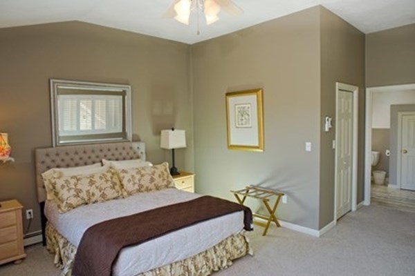 9 Thaxter Lane Edgartown, MA 02539 - Photo 12 of 17 a bedroom with a bed and a chandelier