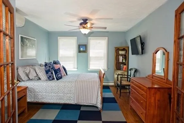 a bedroom with a large bed and a chandelier