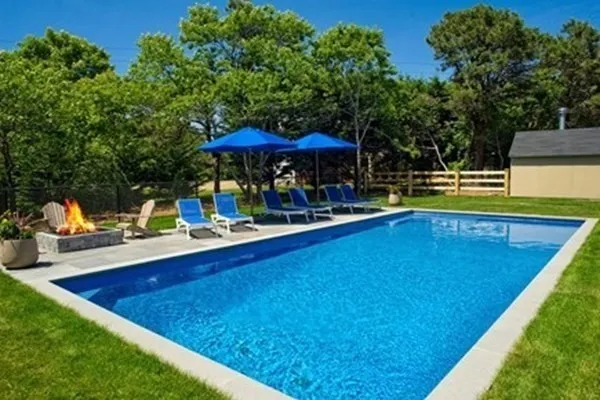 swimming pool view with a seating space