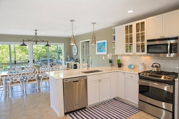 9 Thaxter Lane Edgartown, MA 02539 - Photo 3 of 17 a kitchen with a sink stove and cabinets