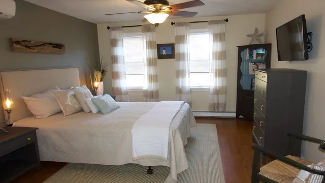 a bedroom with a large bed and a flat screen tv