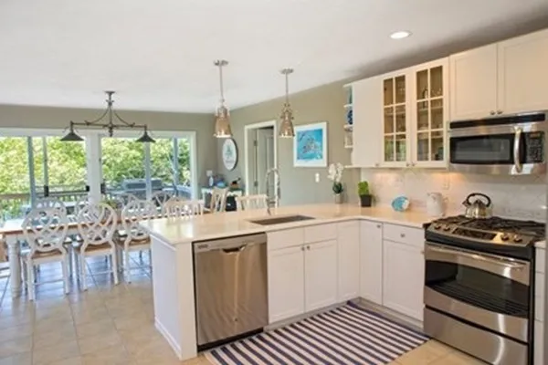 a kitchen with a sink stove and cabinets