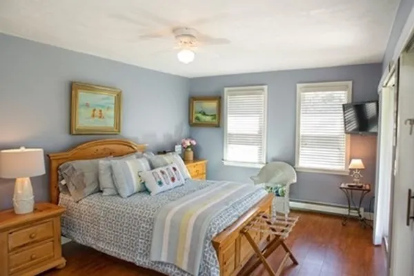 a bedroom with a bed and wooden floor