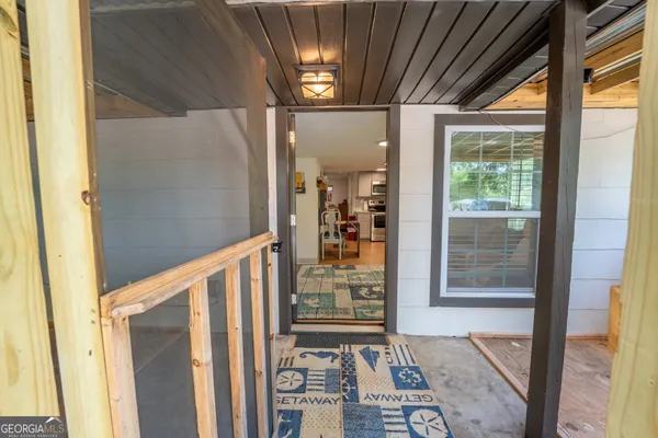 a view of a door and wooden floor