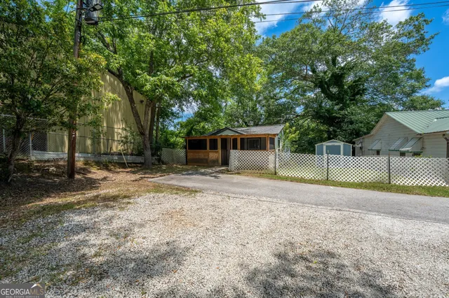 a view of a house with backyard and a tree