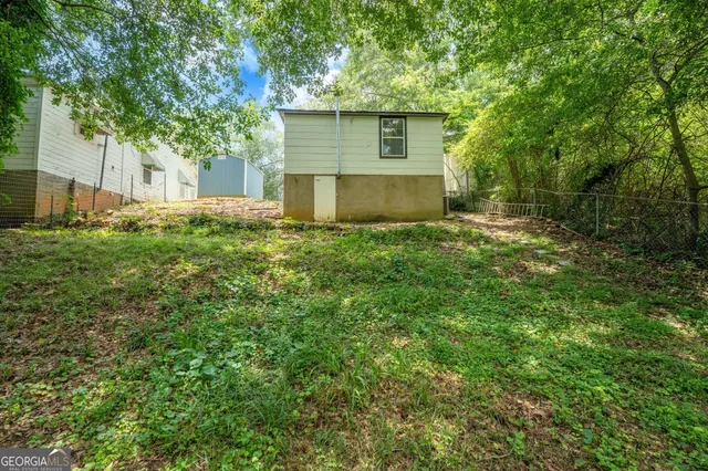 a view of a yard in front of a house with large trees