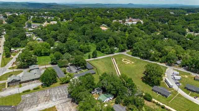 an aerial view of a houses with a yard