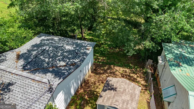 a view of a tree in a backyard of a house