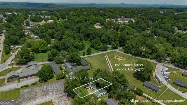 an aerial view of a residential houses with outdoor space and street view