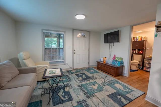 a living room with furniture and a flat screen tv