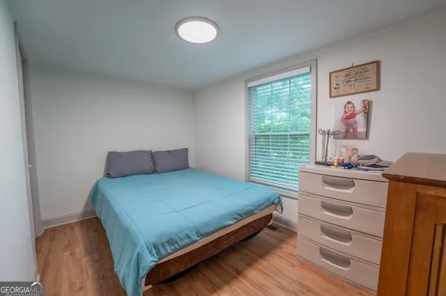 a bedroom with a bed and a window