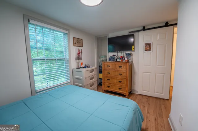 a bedroom with a bed and flat screen tv