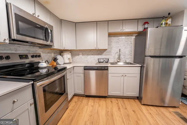 a kitchen with a refrigerator sink and microwave