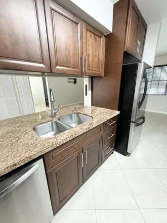 a kitchen with a sink a stove and cabinets