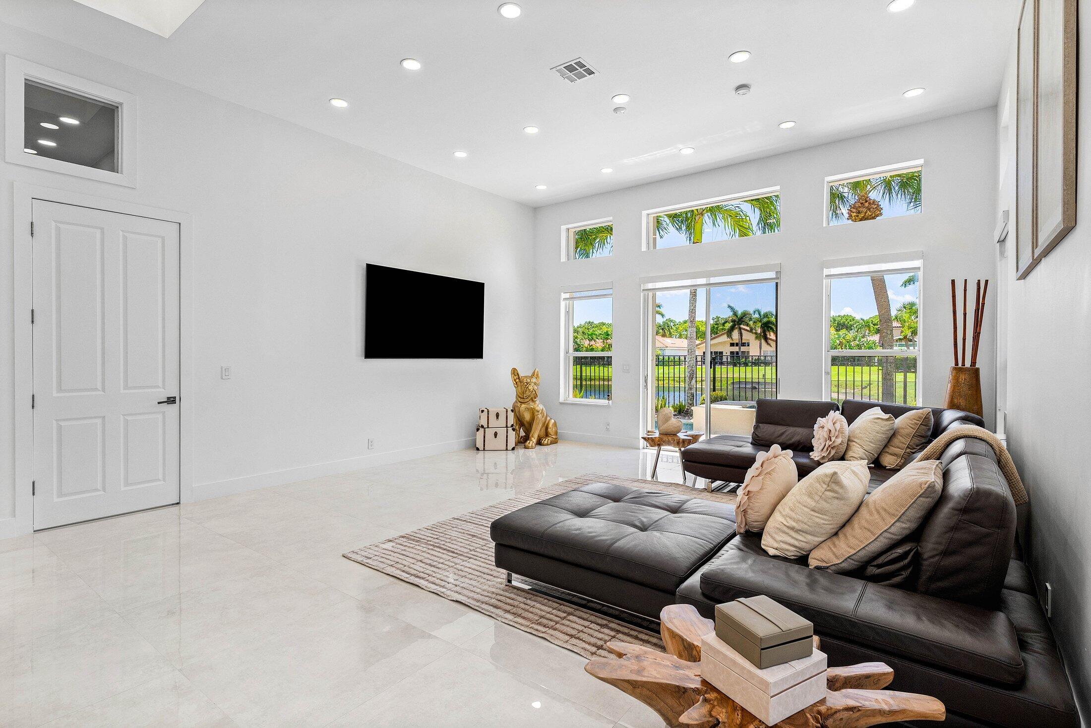 6334 Northwest 24th Street Boca Raton, FL 33434 - Photo 11 of 56 a living room with furniture and a flat screen tv