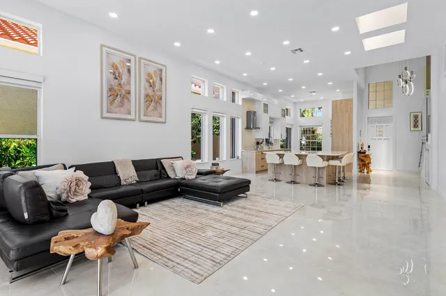 a dining room with furniture and a floor to ceiling window