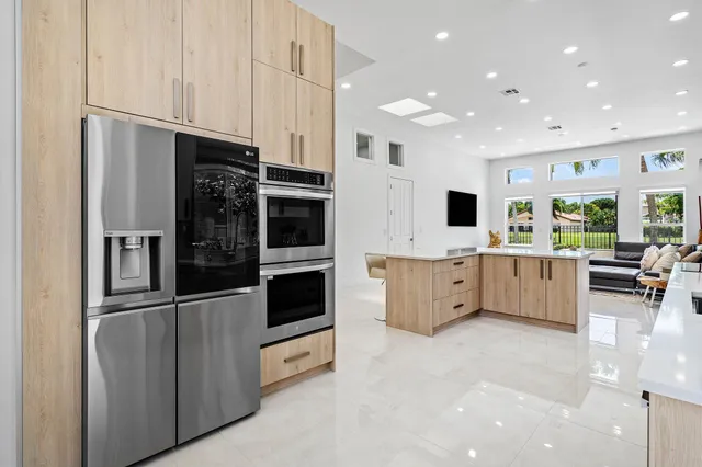 a large kitchen with stainless steel appliances lots of counter space sink and cabinets