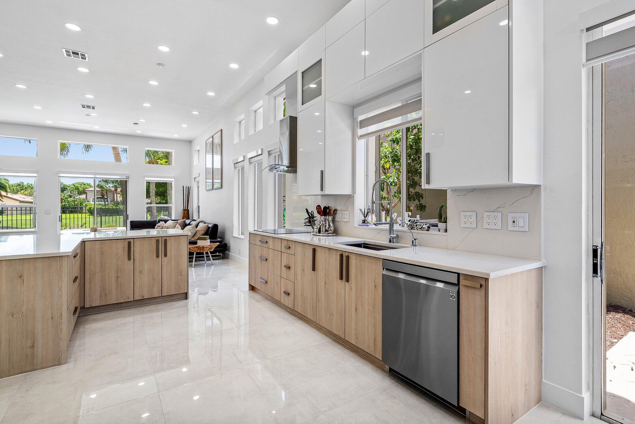 6334 Northwest 24th Street Boca Raton, FL 33434 - Photo 16 of 56 a large white kitchen with a large window