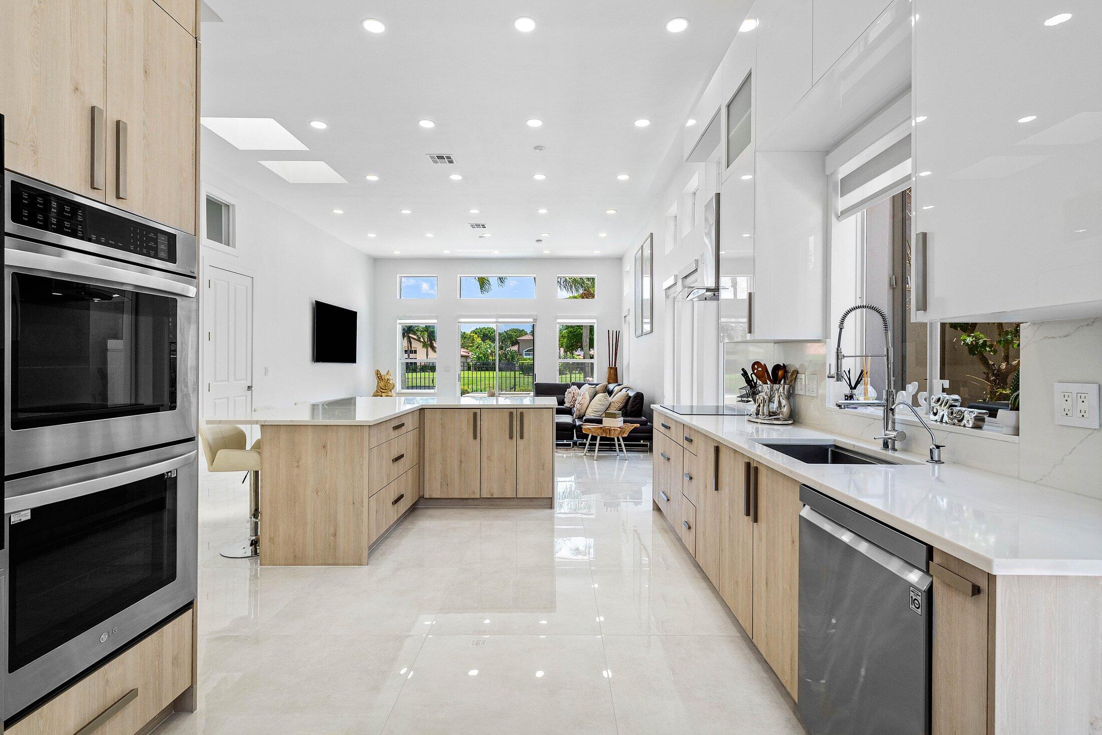 6334 Northwest 24th Street Boca Raton, FL 33434 - Photo 18 of 56 a large kitchen with stainless steel appliances lots of counter space sink and cabinets