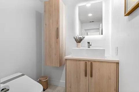 a bed sitting in a spacious bedroom next to a window