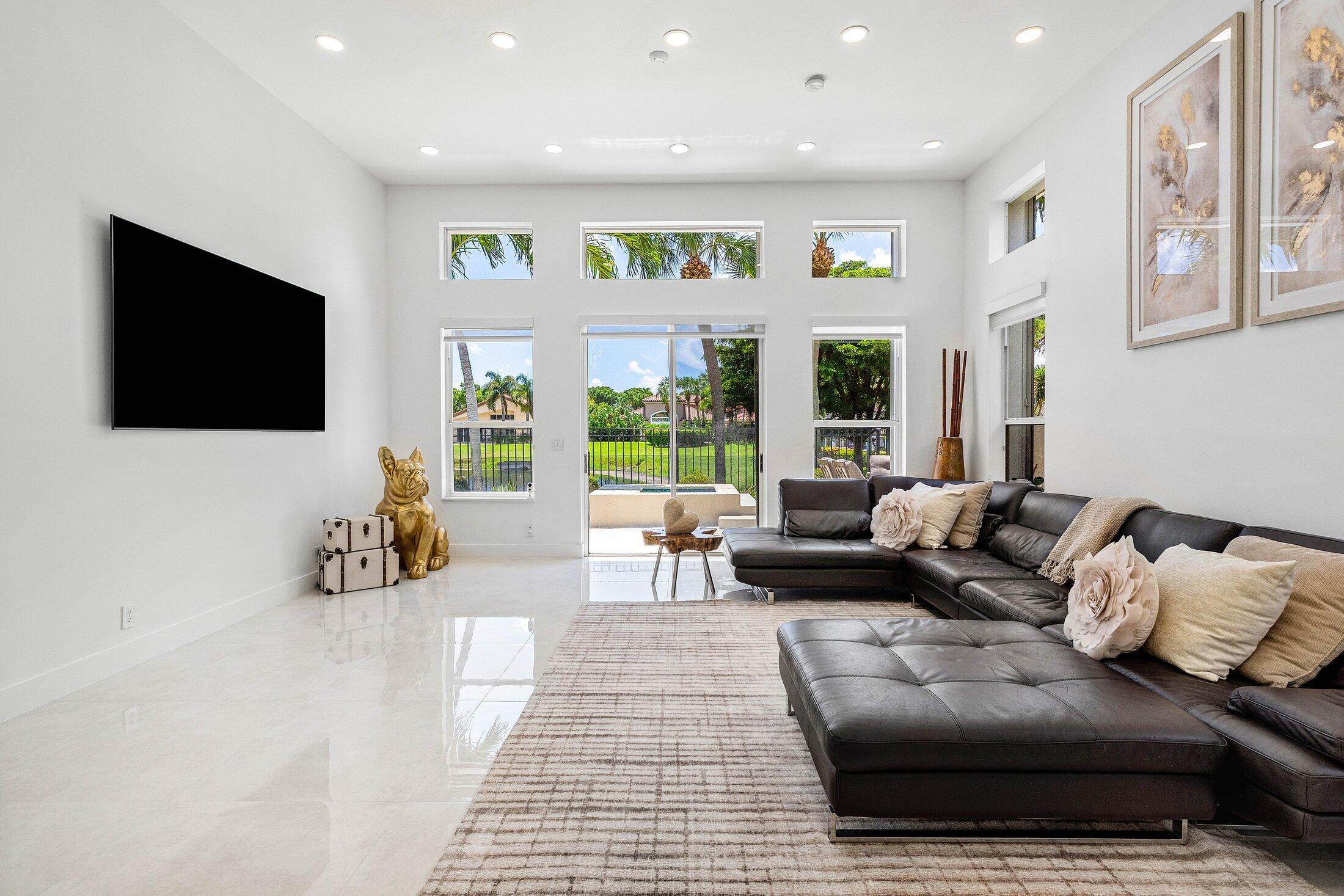 6334 Northwest 24th Street Boca Raton, FL 33434 - Photo 21 of 56 a living room with furniture and a flat screen tv