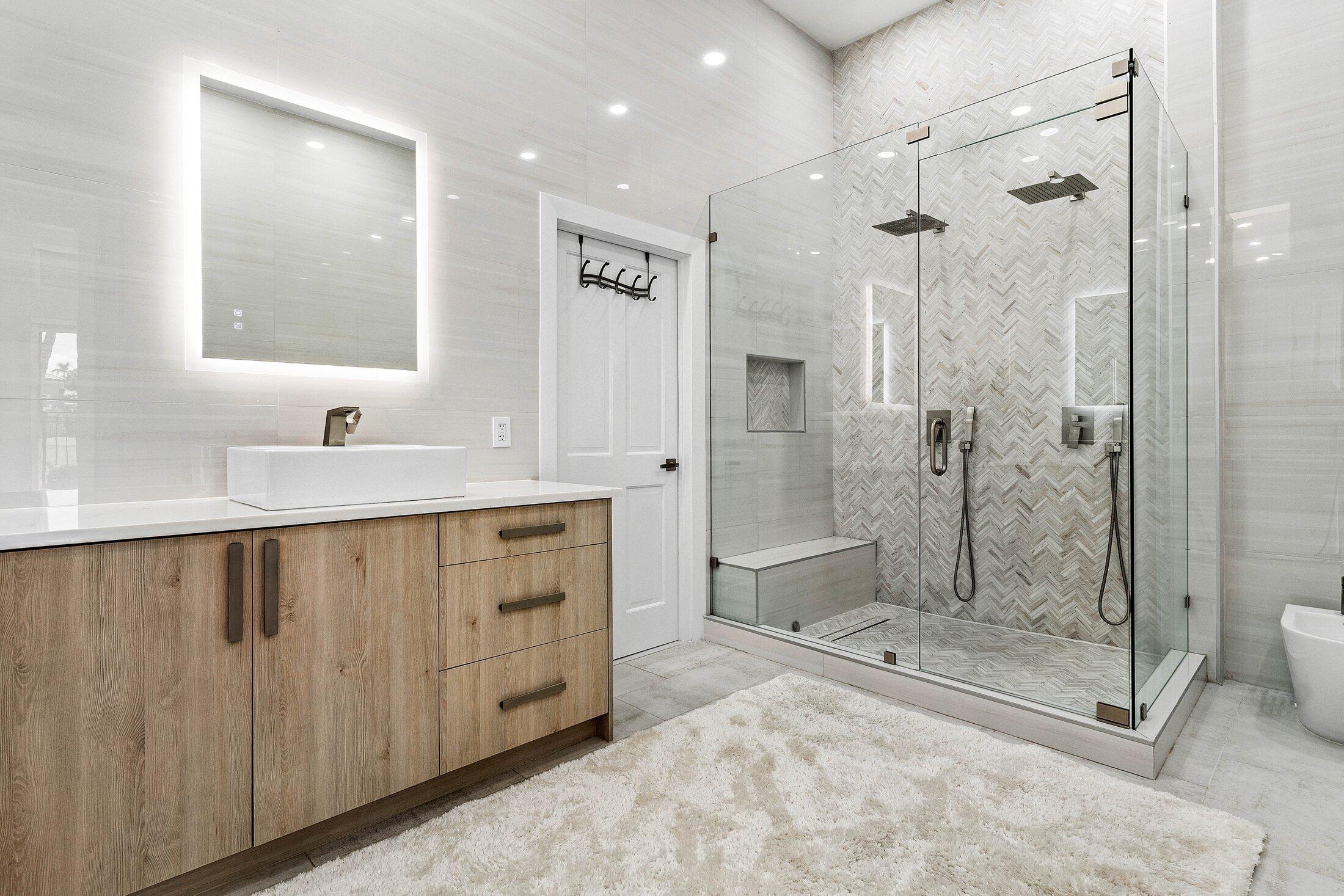 6334 Northwest 24th Street Boca Raton, FL 33434 - Photo 24 of 56 a bathroom with a shower sink and mirror