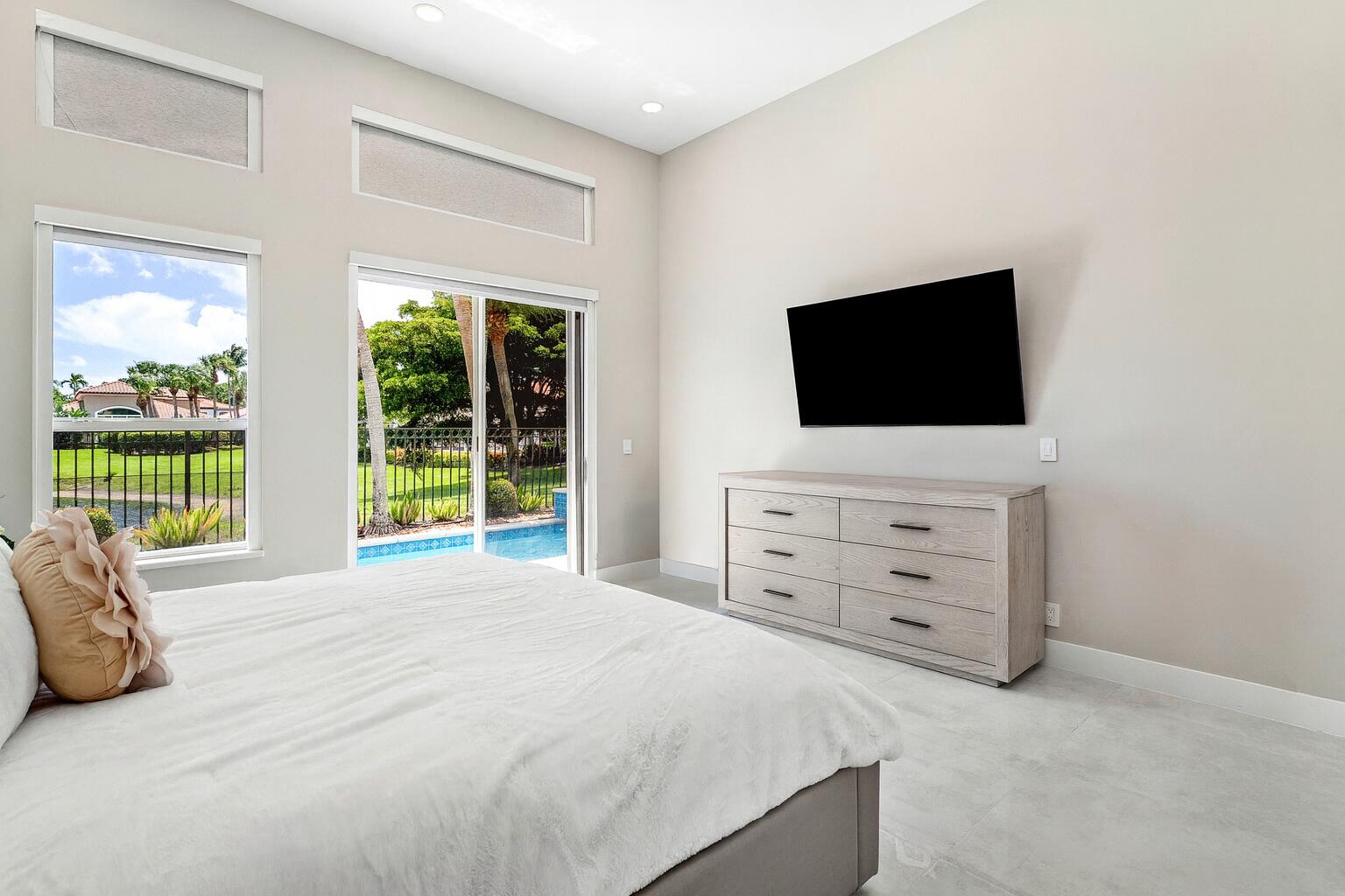 6334 Northwest 24th Street Boca Raton, FL 33434 - Photo 26 of 56 a bedroom with a bed and a flat screen tv