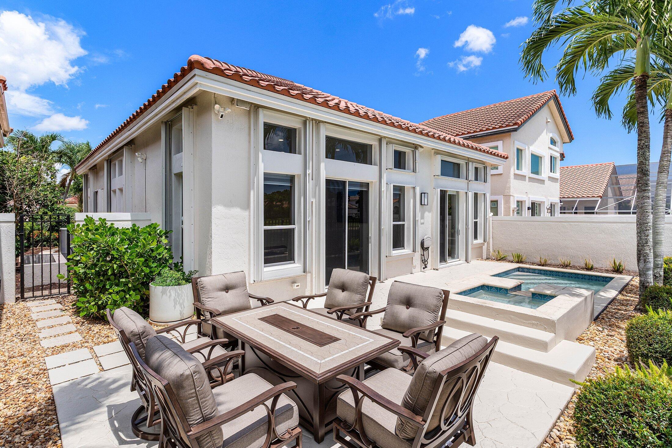 6334 Northwest 24th Street Boca Raton, FL 33434 - Photo 30 of 56 a view of a patio with table and chairs and potted plants