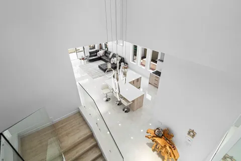 an aerial view of a house with a garden and lake view