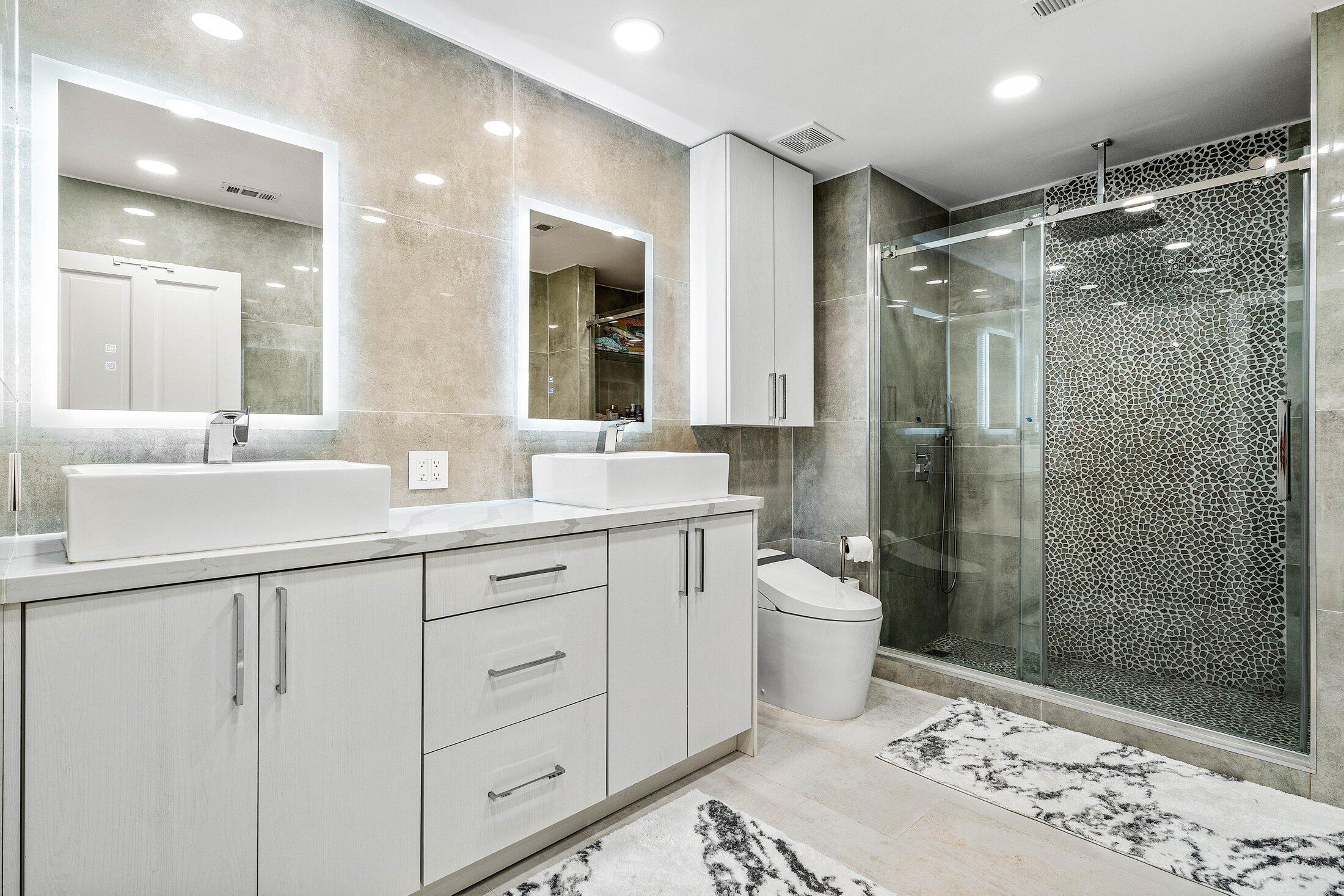 6334 Northwest 24th Street Boca Raton, FL 33434 - Photo 32 of 56 a bathroom with a double vanity sink toilet and shower