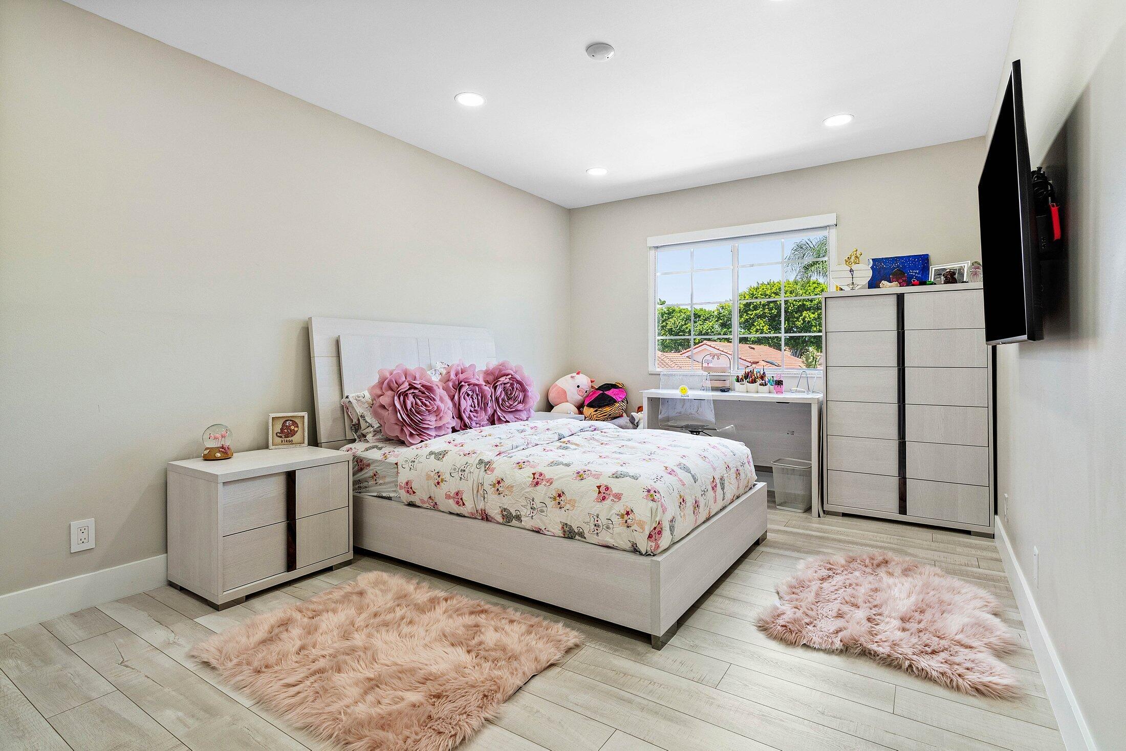 6334 Northwest 24th Street Boca Raton, FL 33434 - Photo 33 of 56 a bedroom with a bed and a flat screen tv