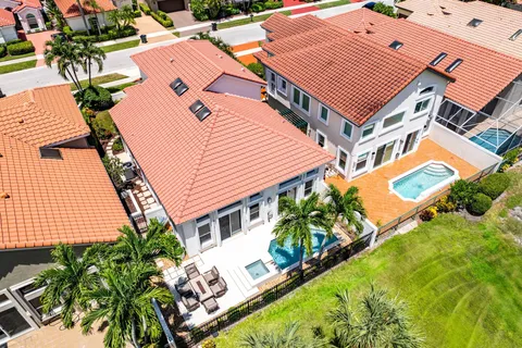 a view of a house with a yard and potted plants