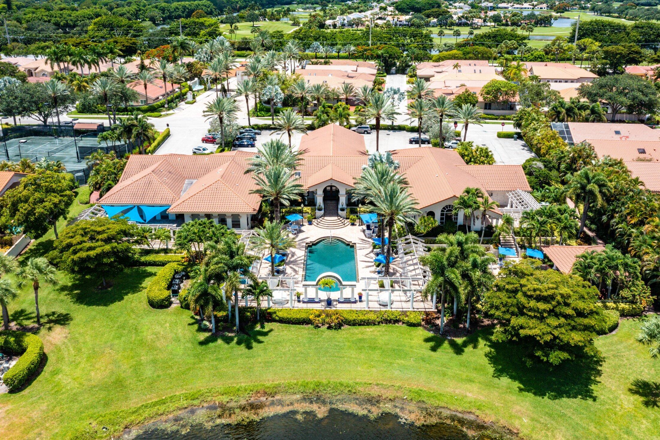 6334 Northwest 24th Street Boca Raton, FL 33434 - Photo 42 of 56 a view of a lake with a house swimming pool a yard and a garden
