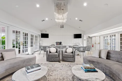 a view of a room with gym equipment and large windows