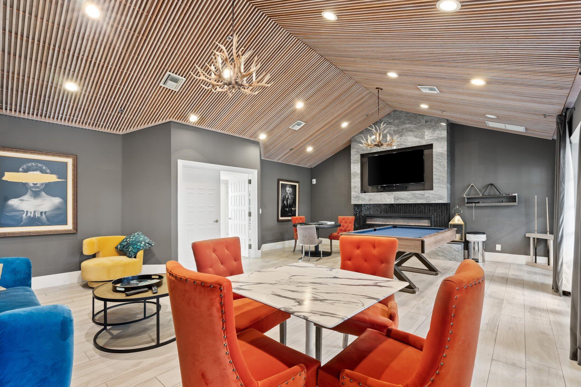 6334 Northwest 24th Street Boca Raton, FL 33434 - Photo 46 of 56 a living room with furniture and a flat screen tv