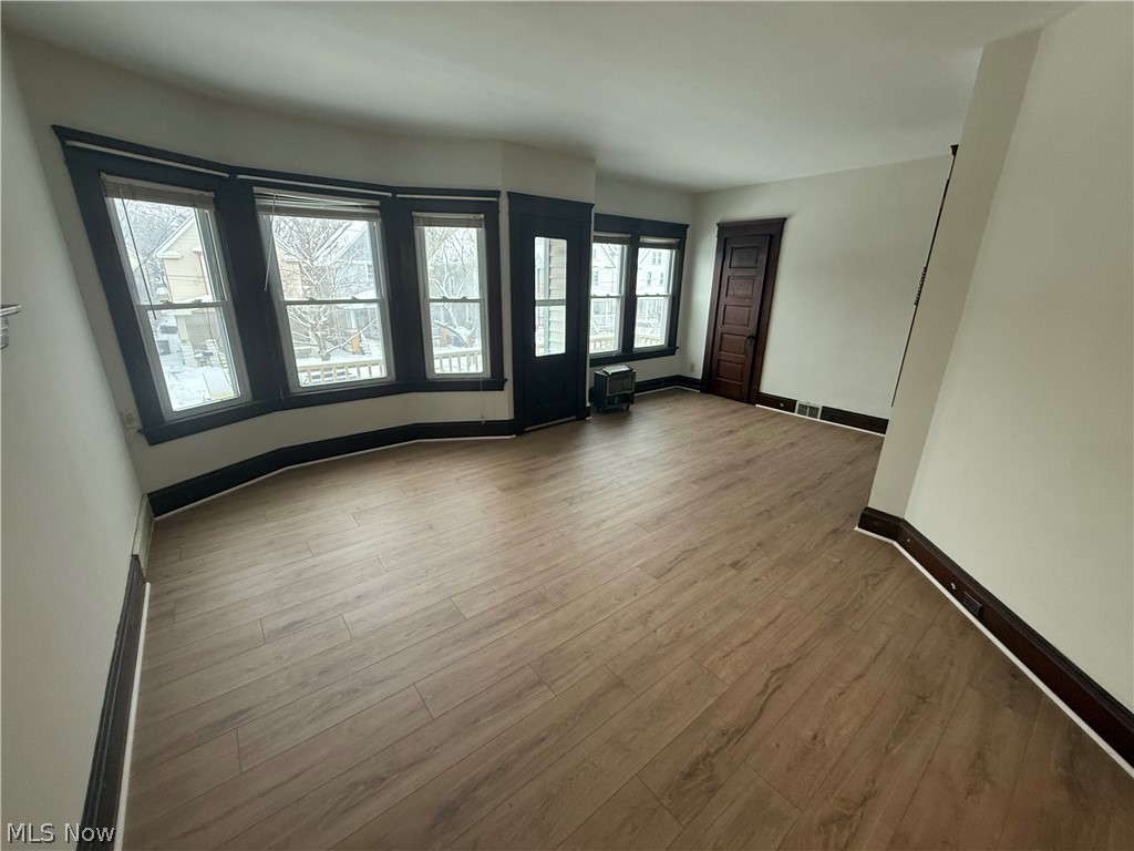 3612 Riverside Avenue Cleveland, OH 44109 - Photo 10 of 22 Spacious room featuring wood-finish flooring, a multi-pane bay window, and light-toned walls
