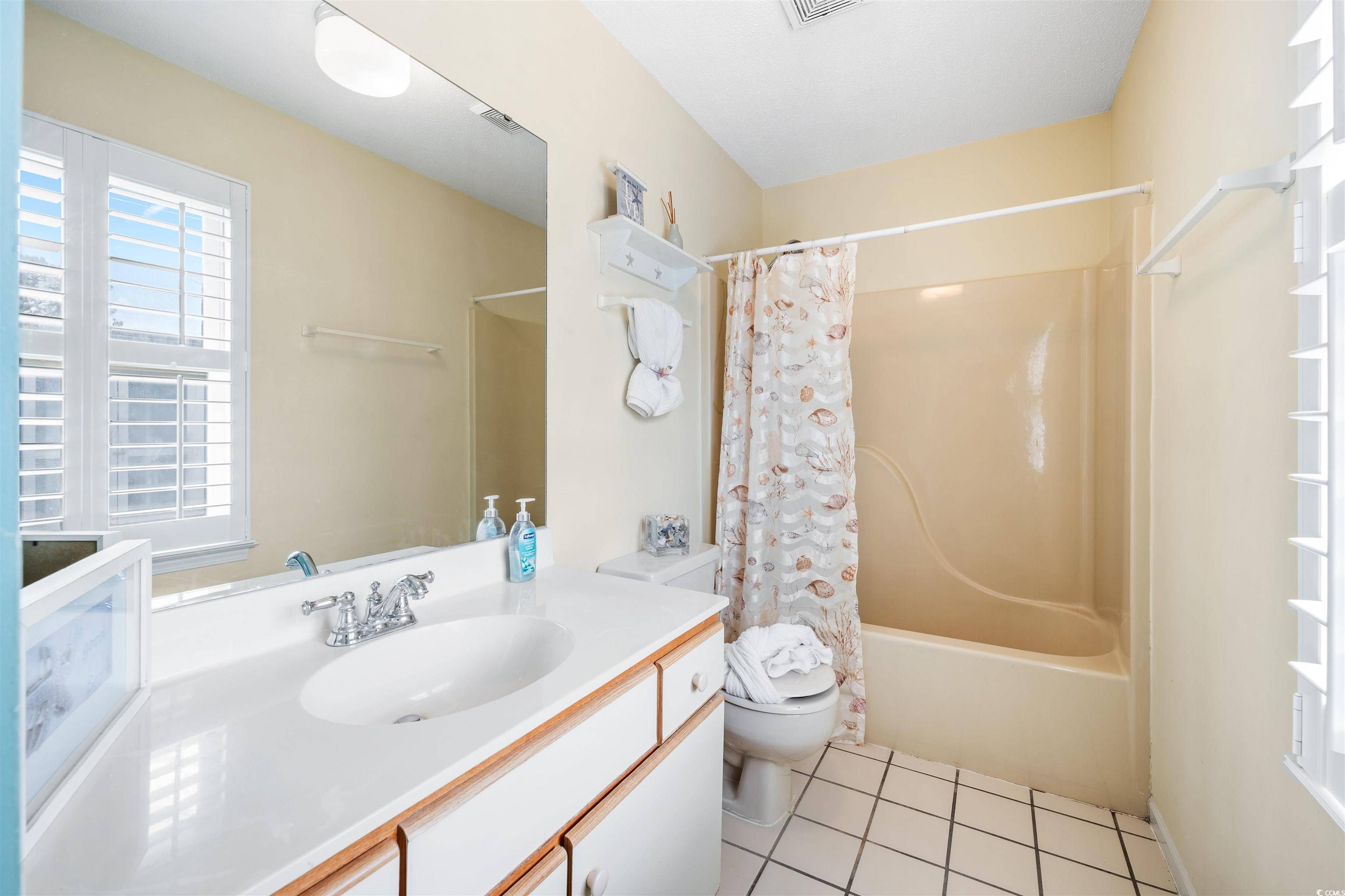1644 Stuart Square Circle Myrtle Beach, SC 29577 - Photo 13 of 21 Full bathroom with tile patterned floors, vanity, toilet, and shower / tub combo