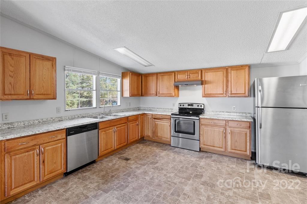7237 Long Island Road Catawba, NC 28609 - Photo 11 of 36 a kitchen with granite countertop stainless steel appliances a refrigerator sink and microwave