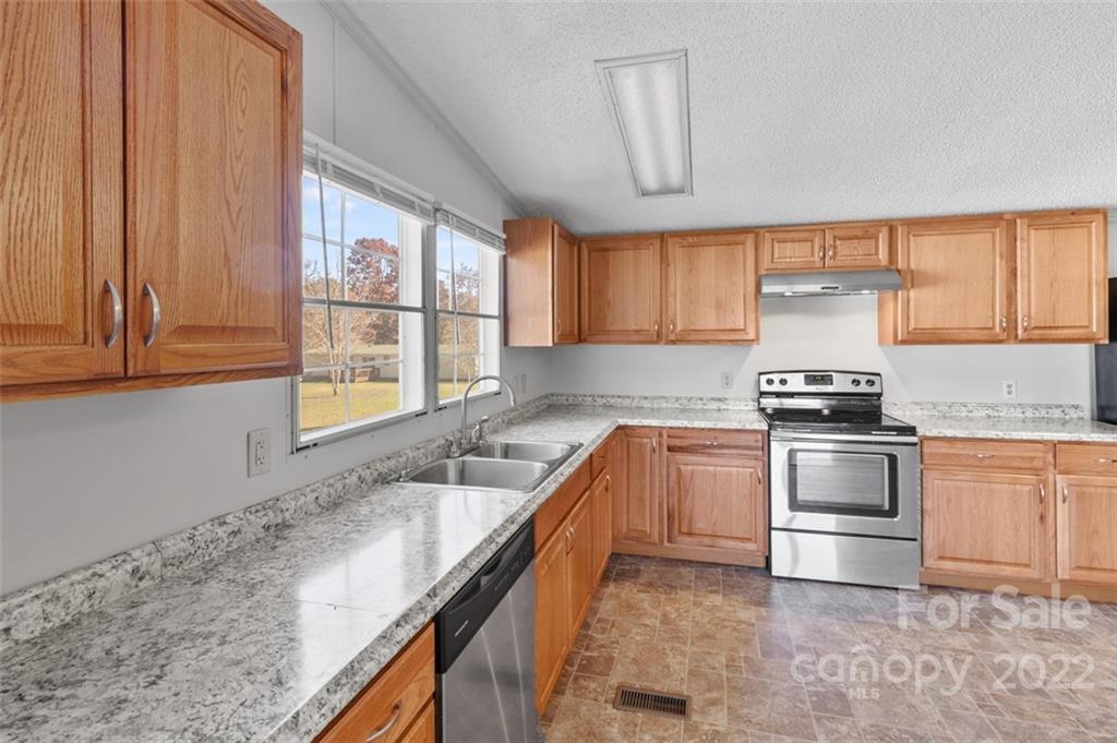 7237 Long Island Road Catawba, NC 28609 - Photo 12 of 36 a kitchen with granite countertop a stove and a sink