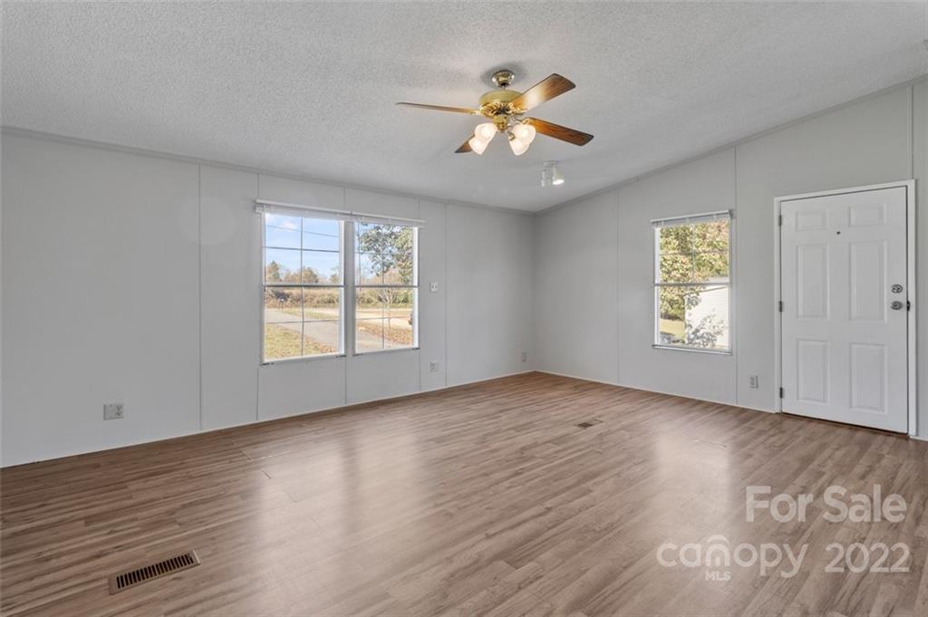 7237 Long Island Road Catawba, NC 28609 - Photo 13 of 36 a view of an empty room with wooden floor and a window